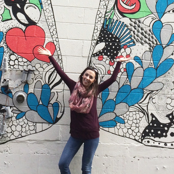 Me in front of a mural with butterfly wings