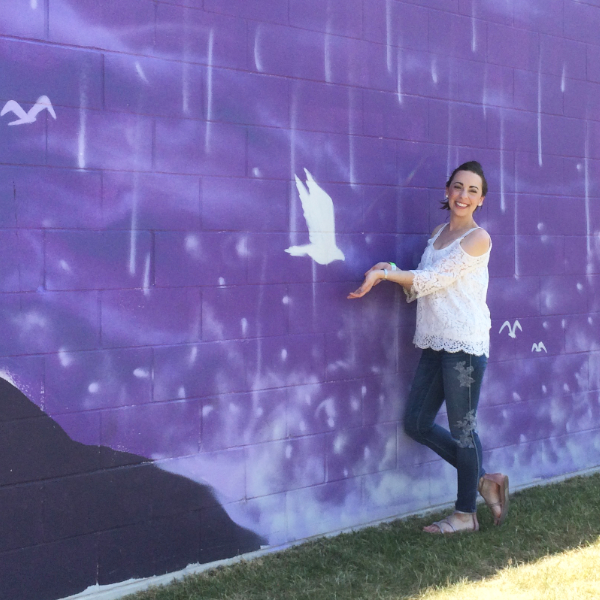 Me and a white dove painted on a purple mural